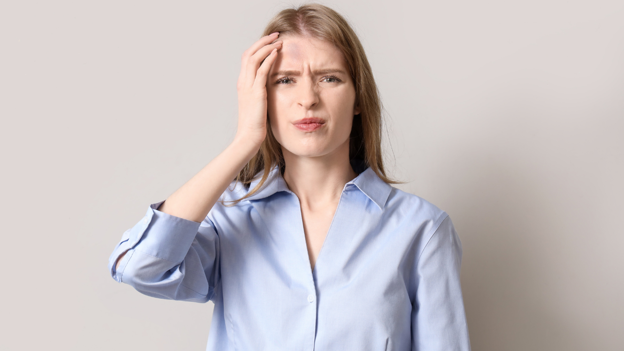 Woman holding her head from a concussion